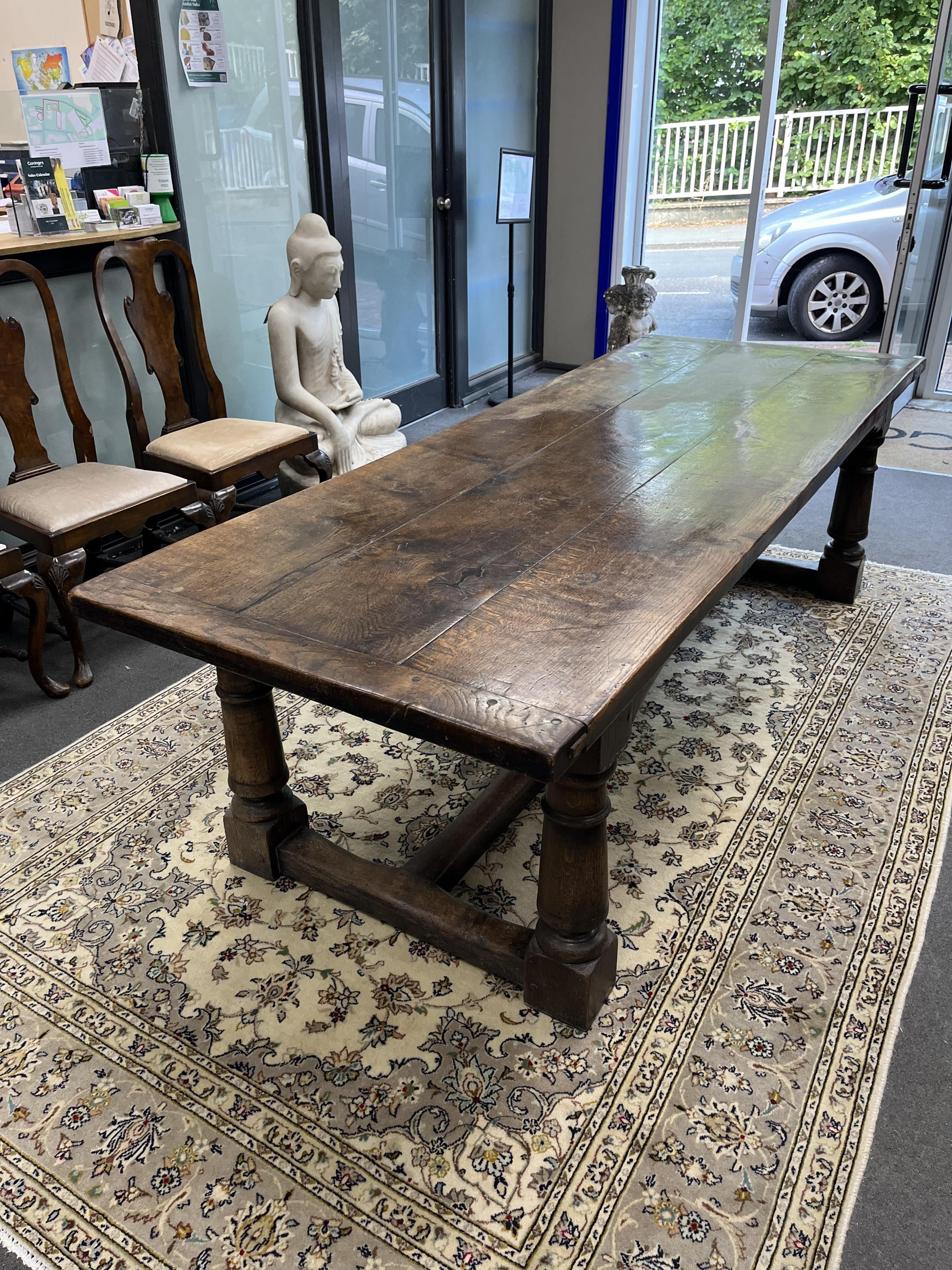 An 18th century style rectangular oak refectory dining table, width 243cm, depth 90cm, height 72cm. Condition - fair